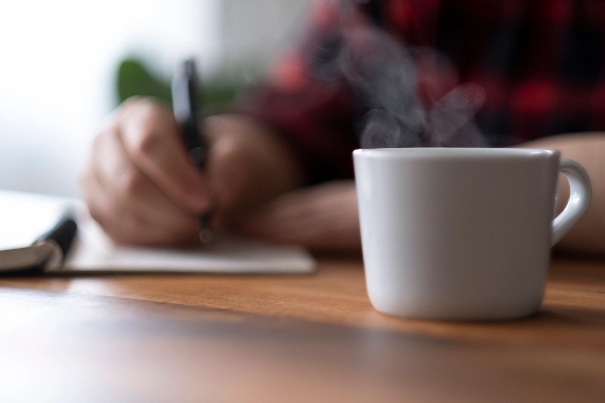 Close up of woman holding a cup of coffee